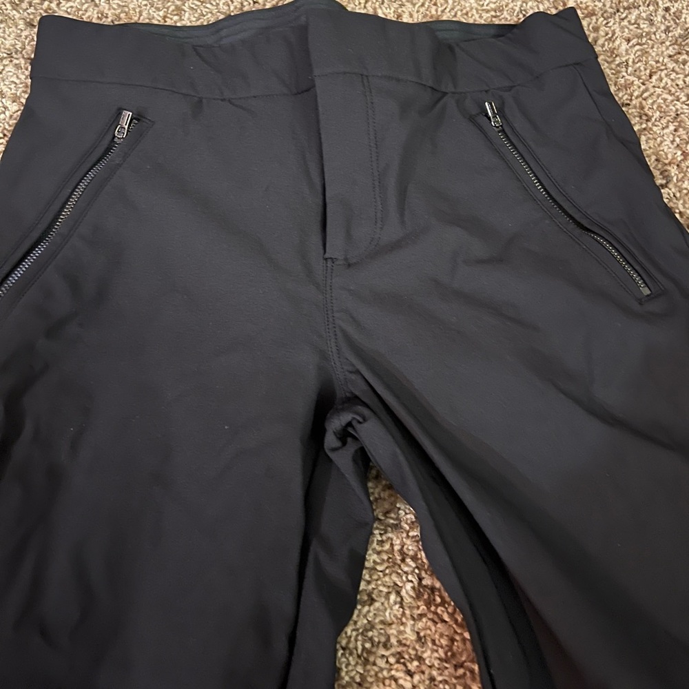 Athleta size 4 black pants. Stretchy. Pull-string cuff, pockets & side zippers. - Picture 4 of 7